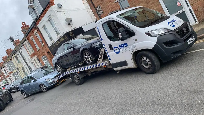 Rapid Recovery truck carrying a vehicle in Northamptonshire